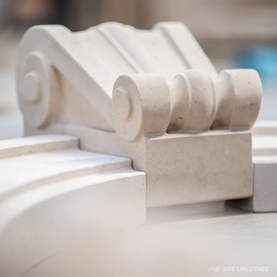 Sculpted scroll corbels arranged in the workshop