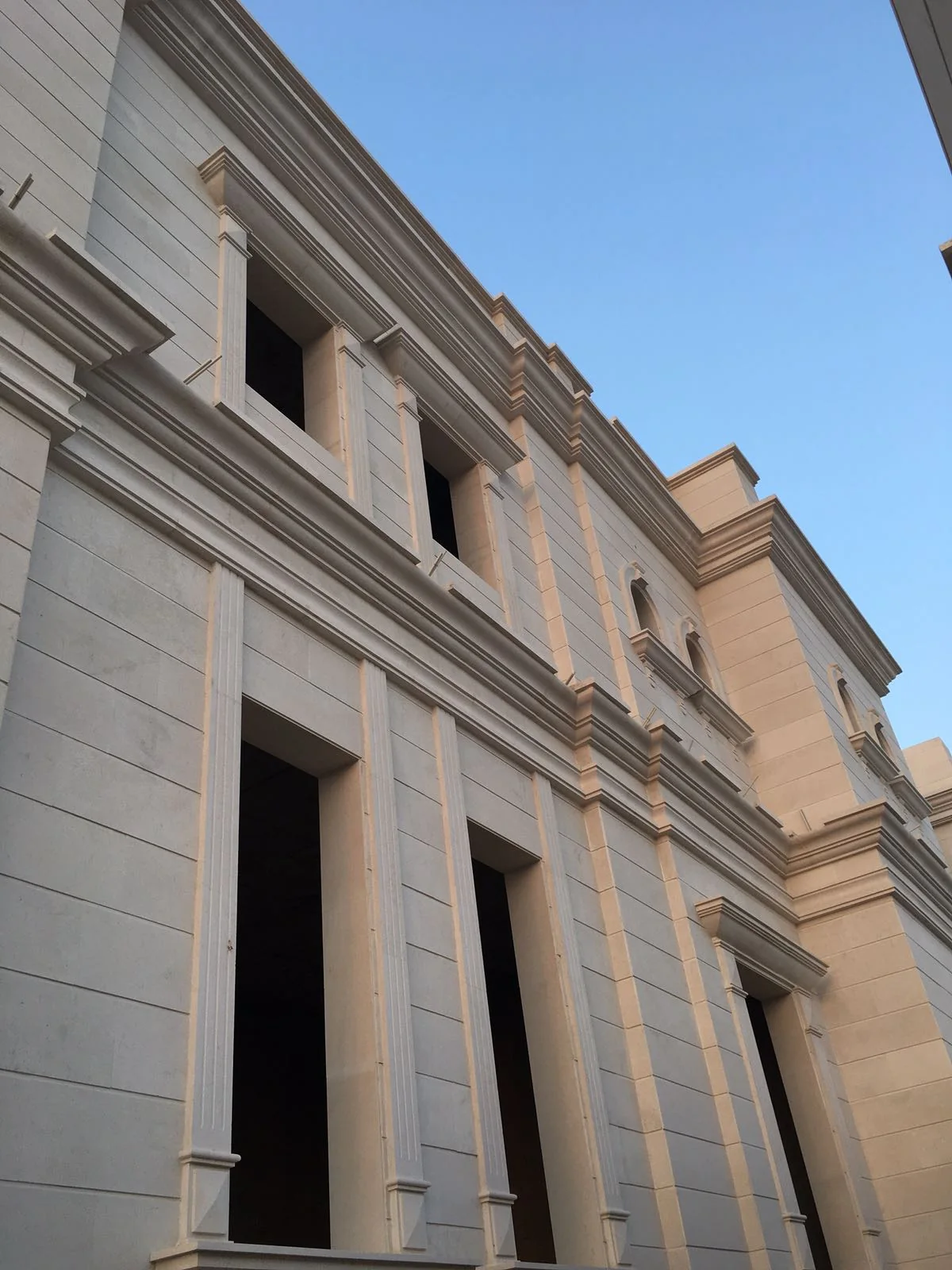 Upper cornice and horizontal mouldings on a residential facade