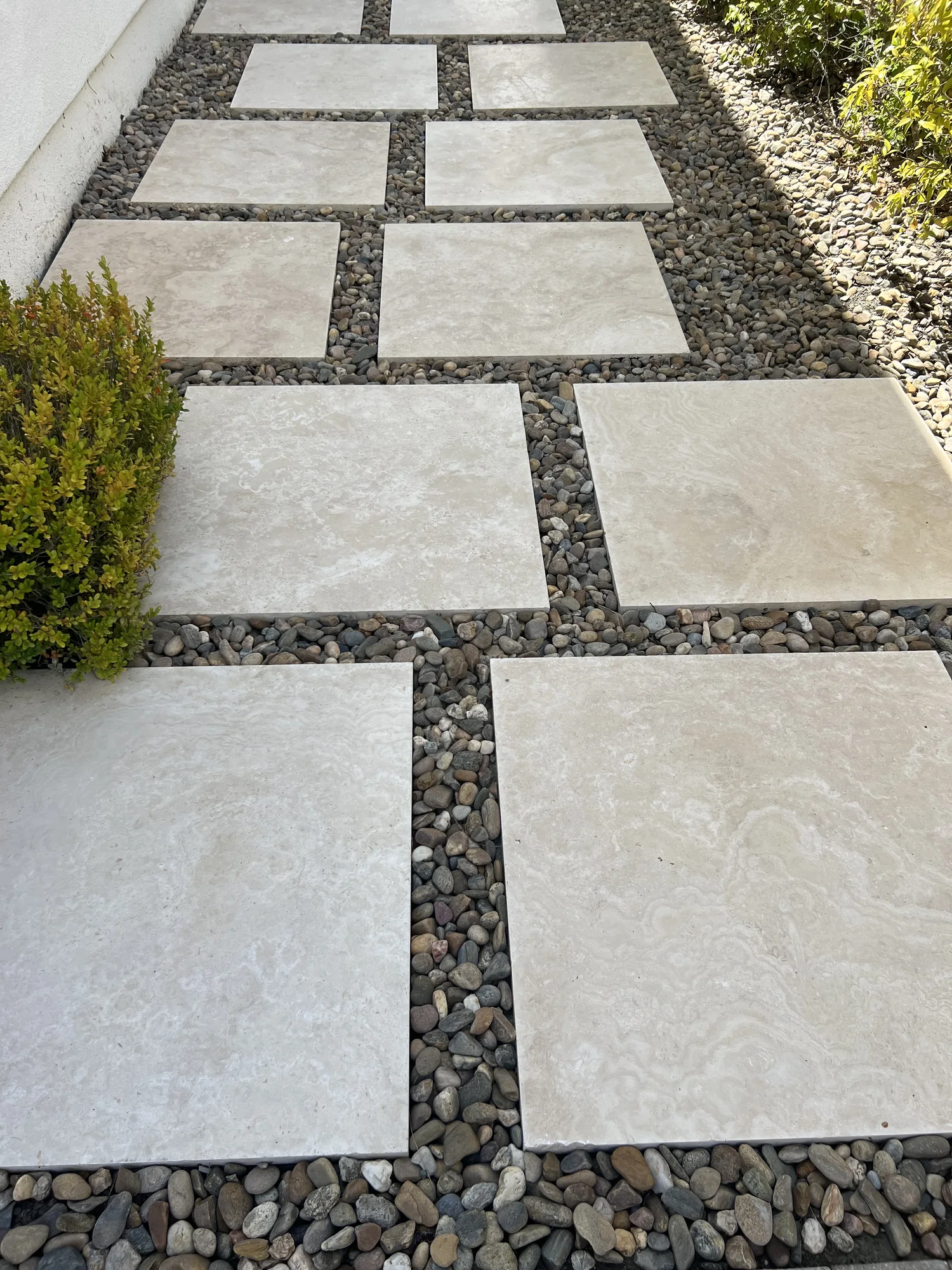 Large rectangular pavers laid with open gravel joints
