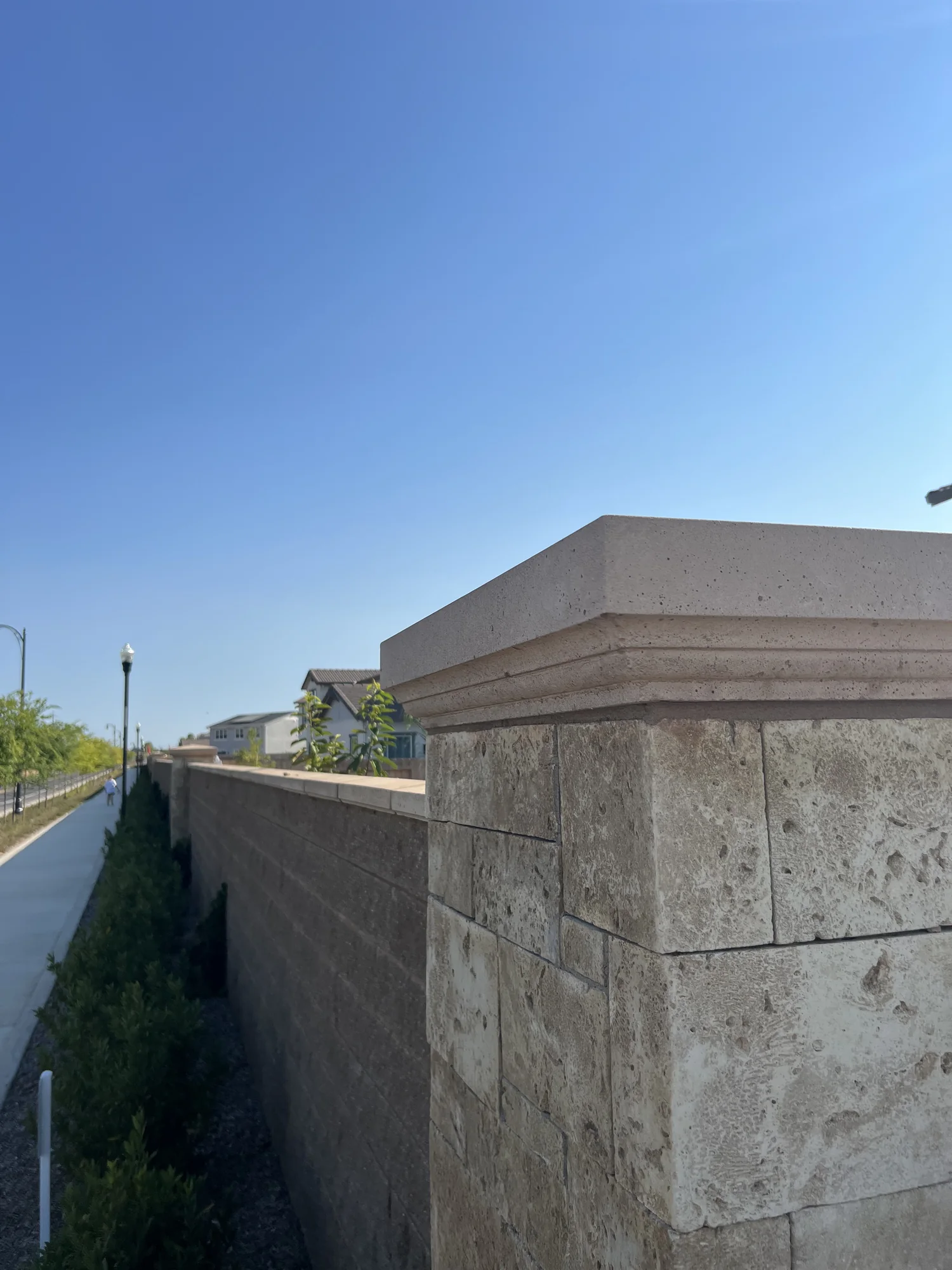 Layered projecting pier cap on a masonry post