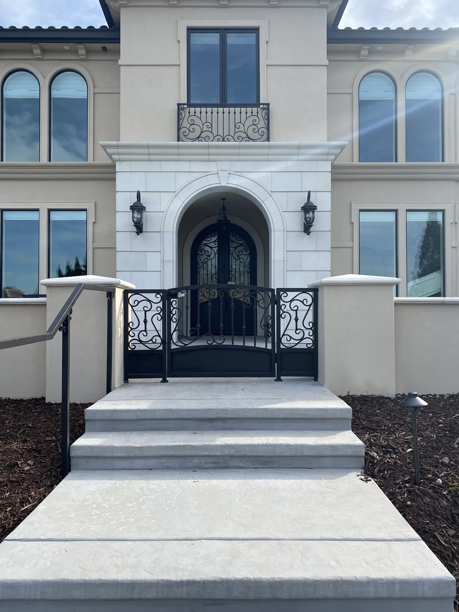 Exterior stair treads and landings leading to a garden gate