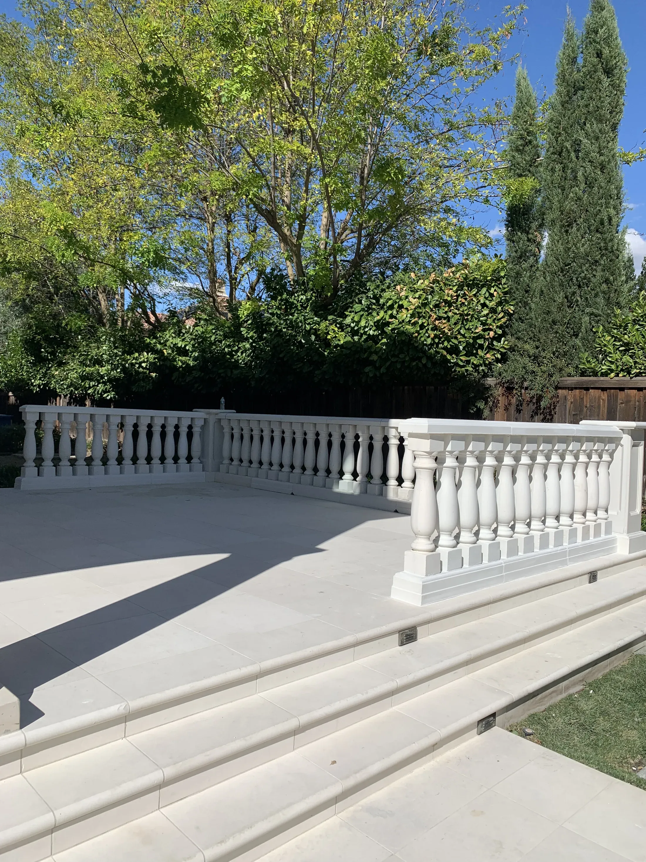 Cast balusters, posts, and rails enclosing a raised terrace