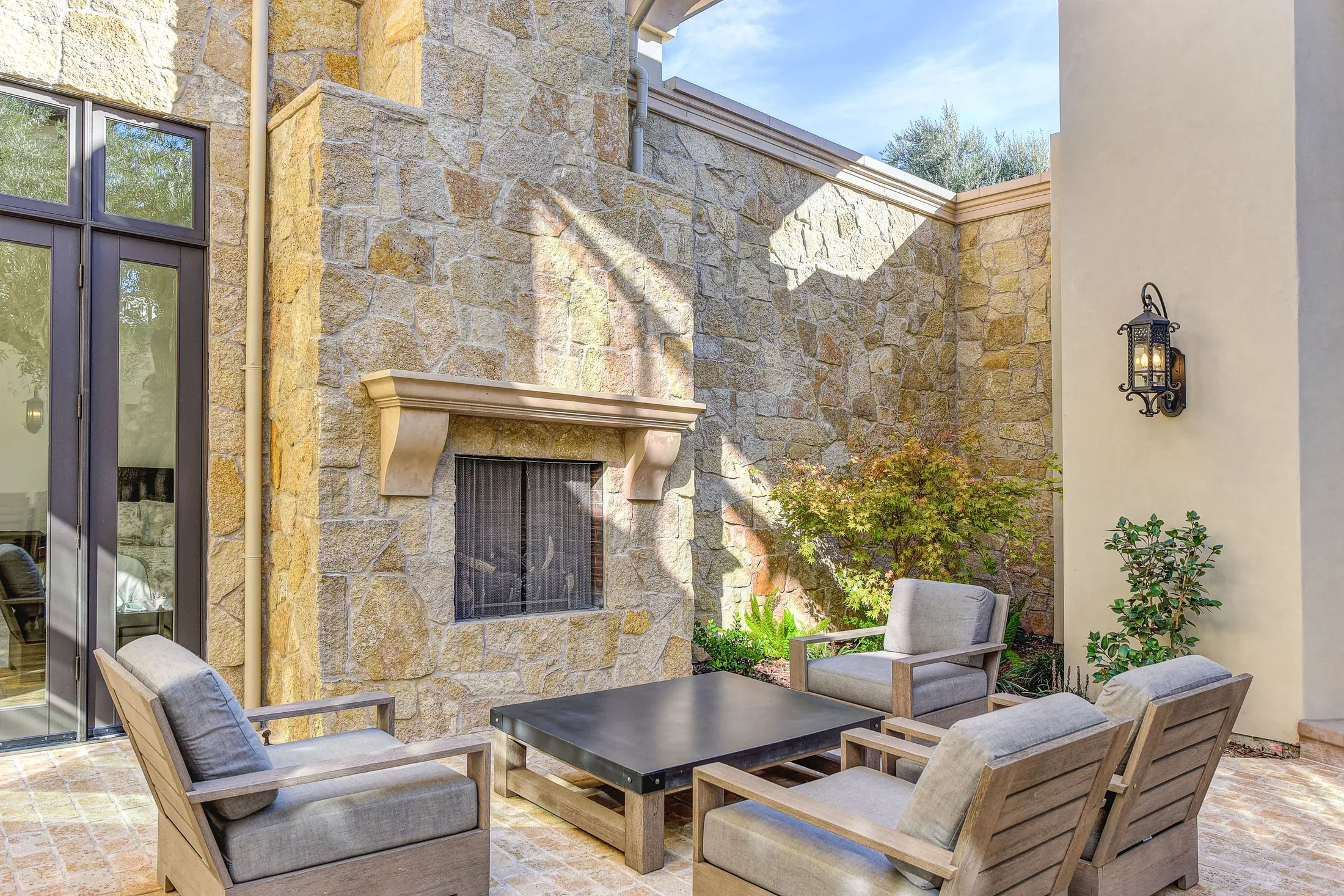 Outdoor mantel and chimney surrounded by stone masonry