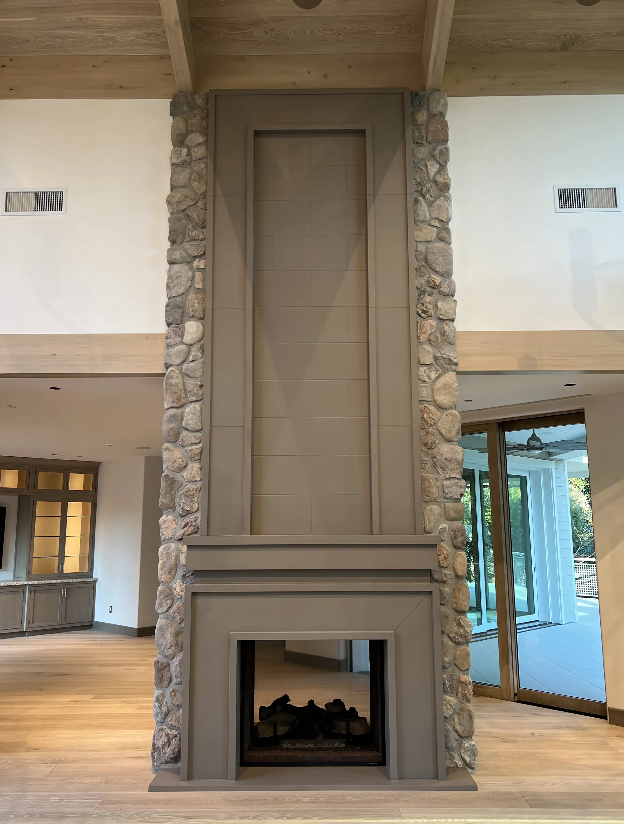 Tall mantel with an ornamental overmantel panel