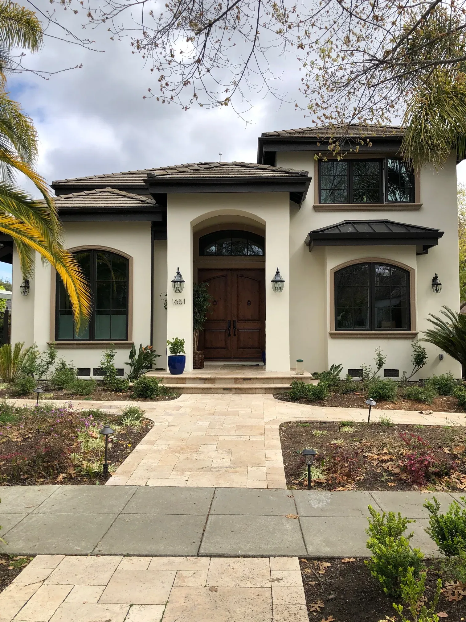 Residence with lightweight mouldings around windows, doors, and rooflines