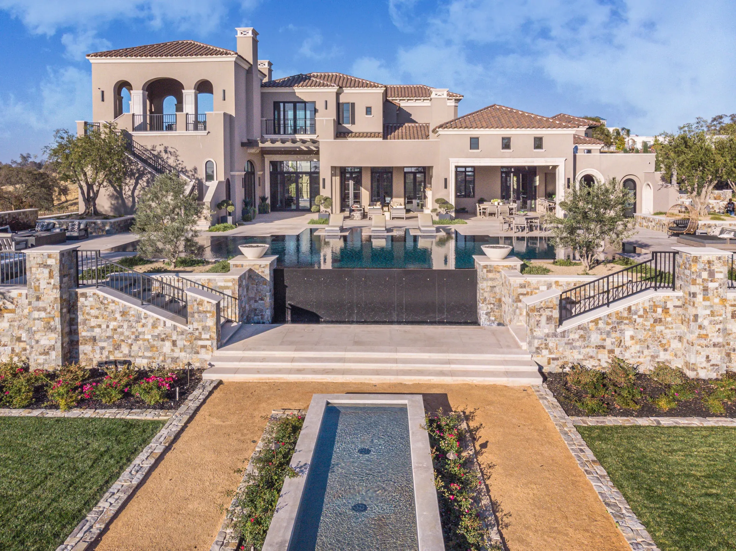 Paved paths and steps around a formal garden water feature
