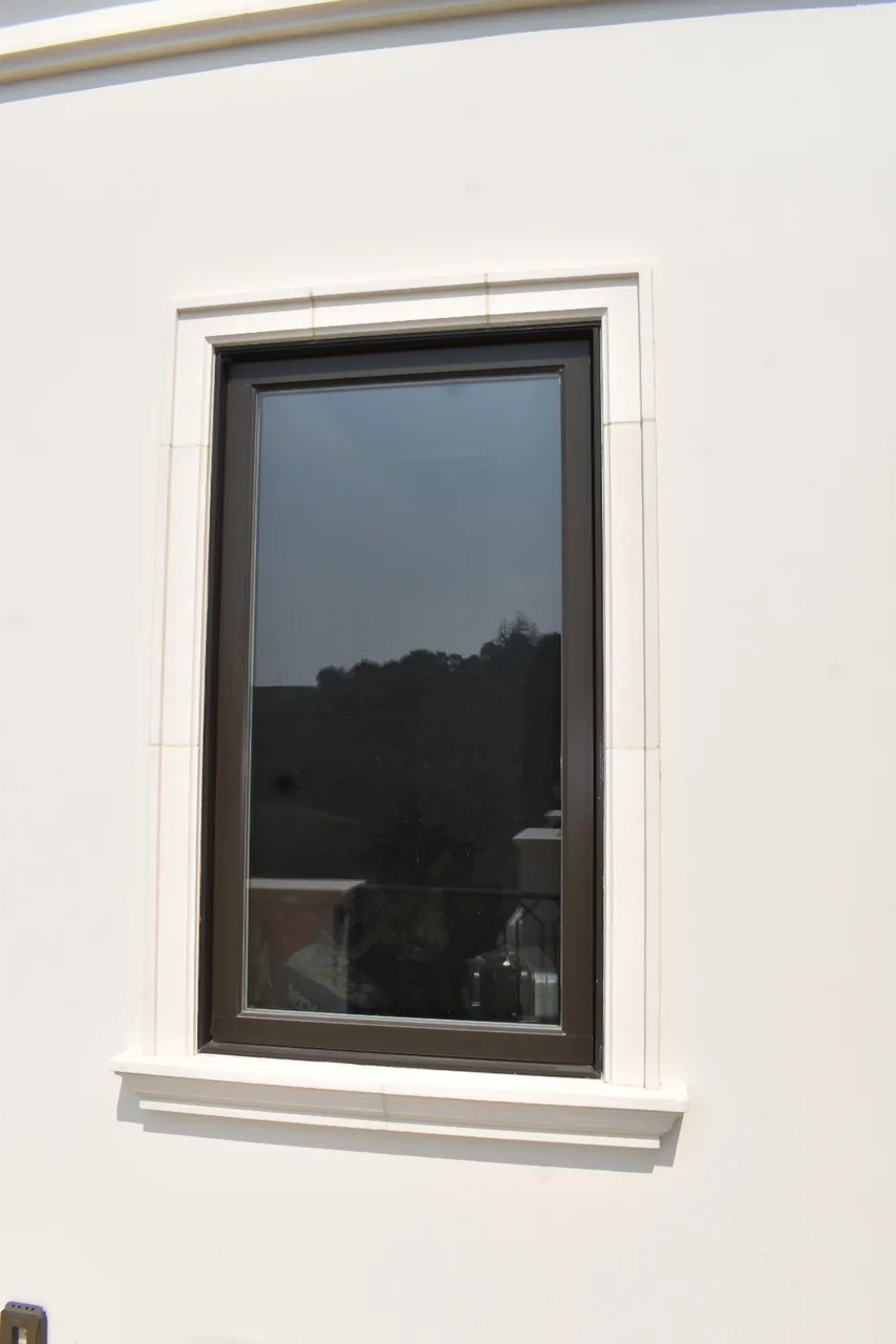 Narrow window with a simple surround and projecting sill