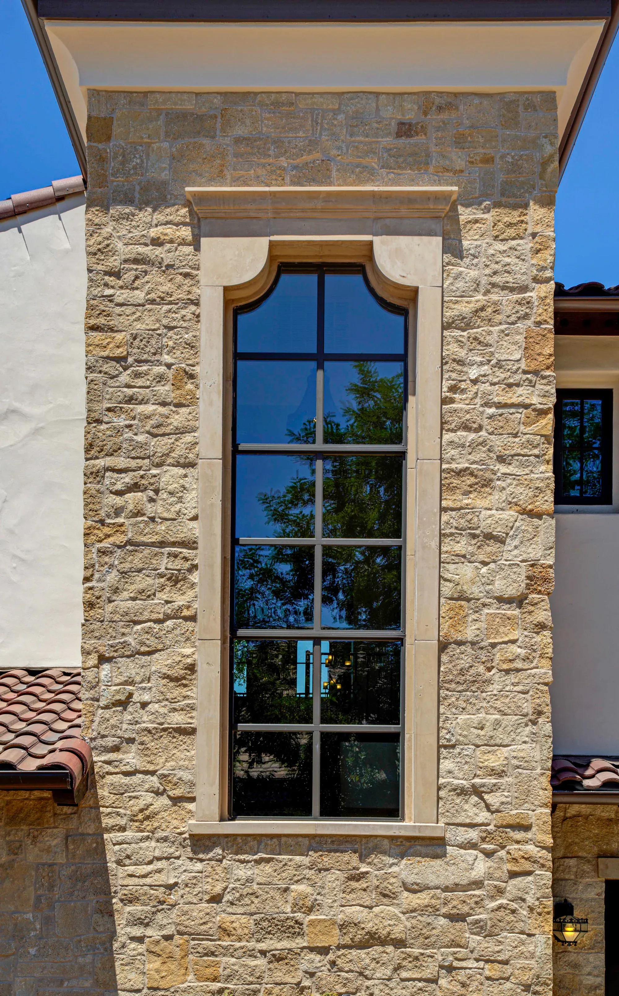 Tall window with a projecting sill against a stone wall