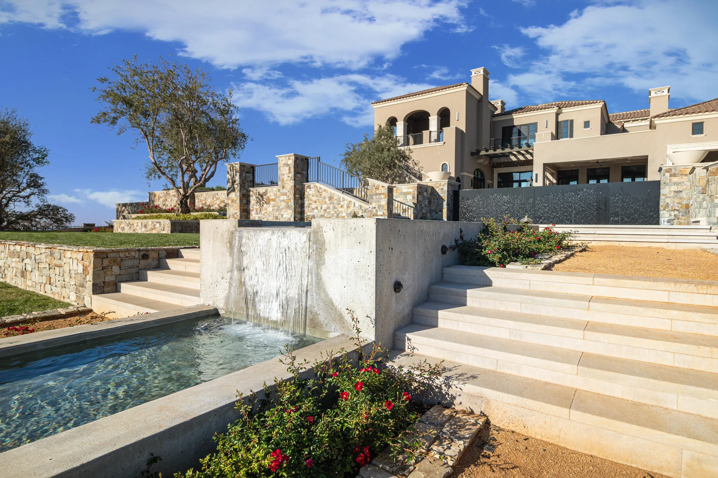 Broad landscape stairs on either side of a cascading water feature