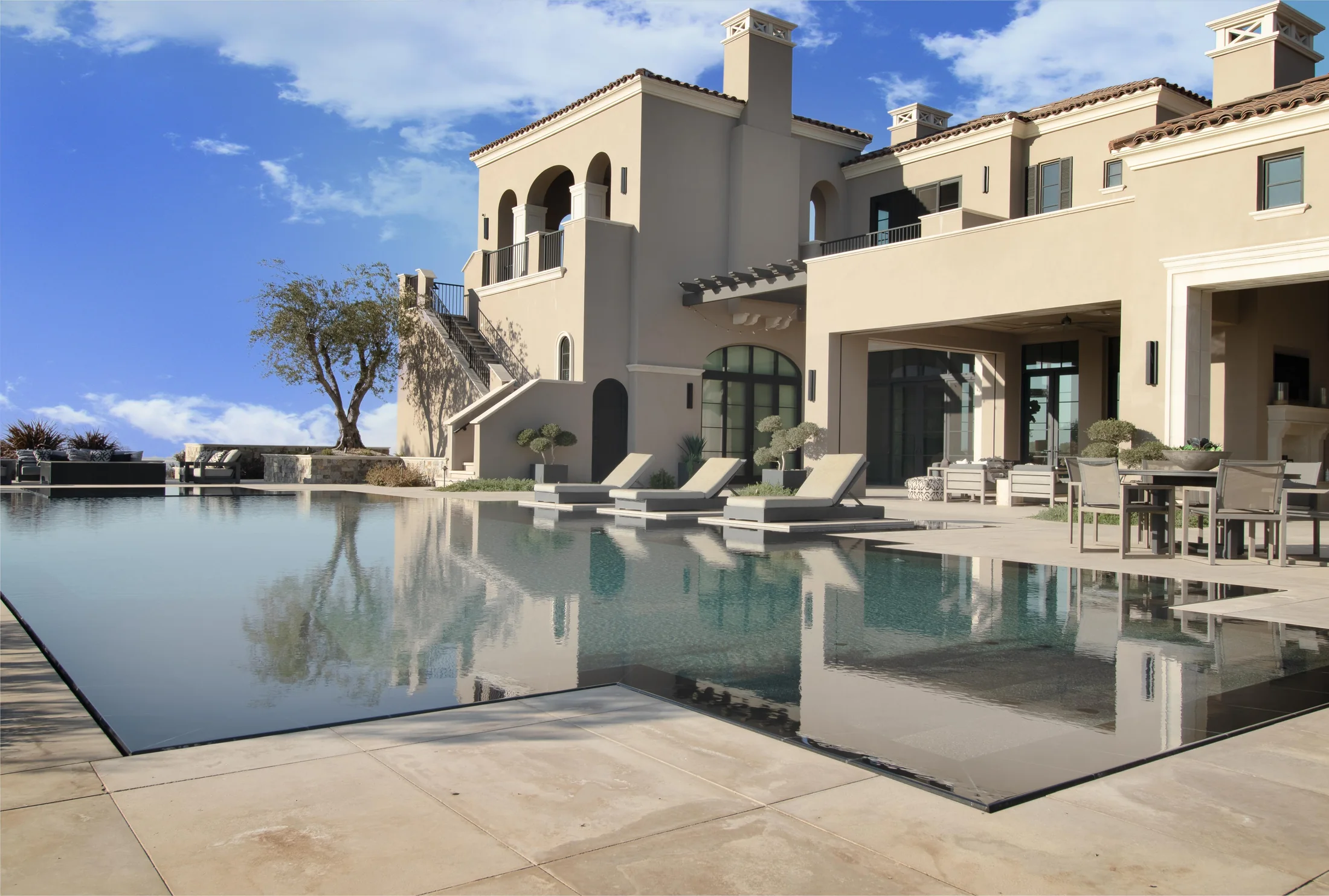 Pool landscape with coordinated paving, coping, caps, and architectural stone