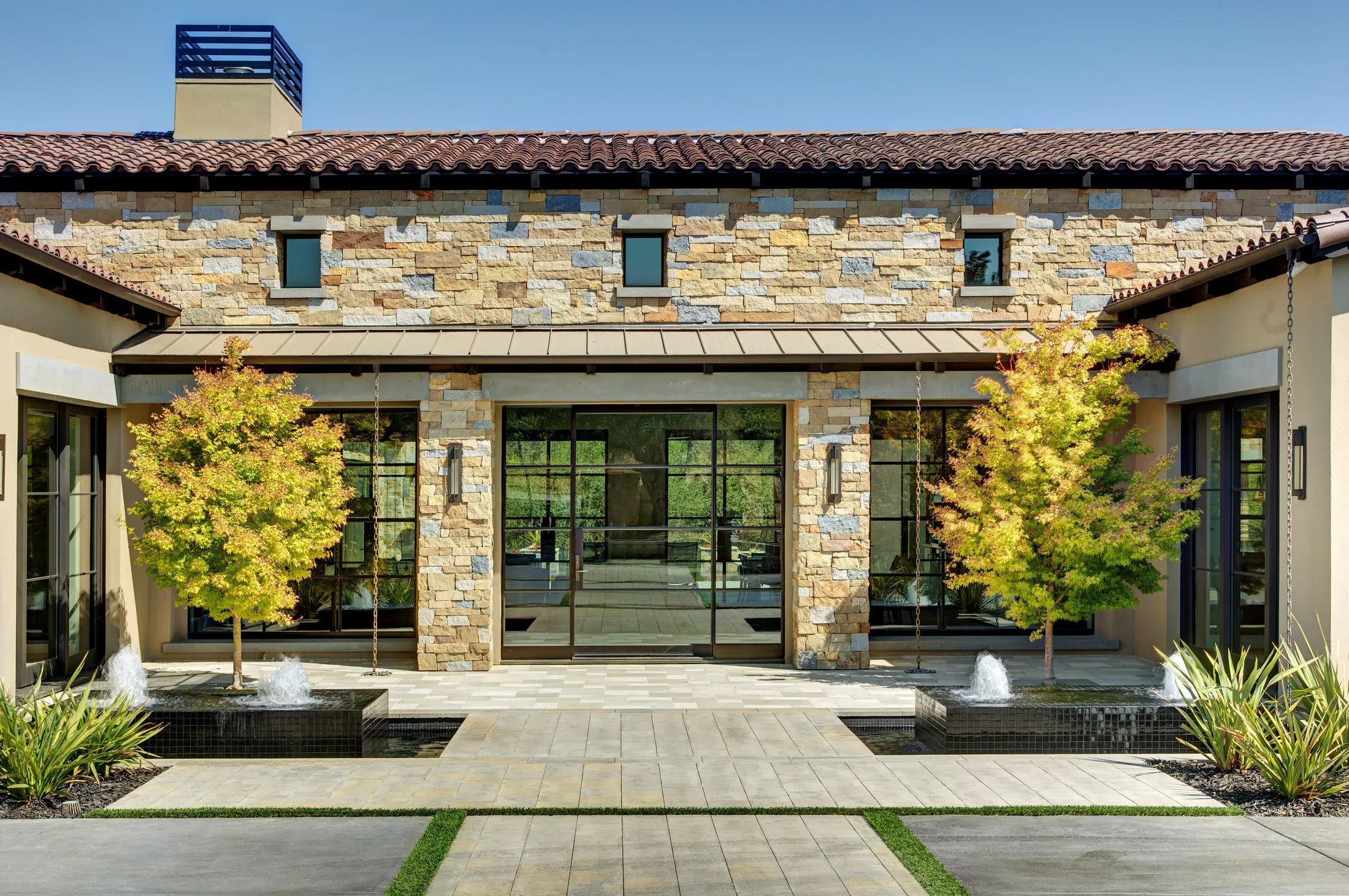 Modern courtyard house with natural stone and architectural concrete