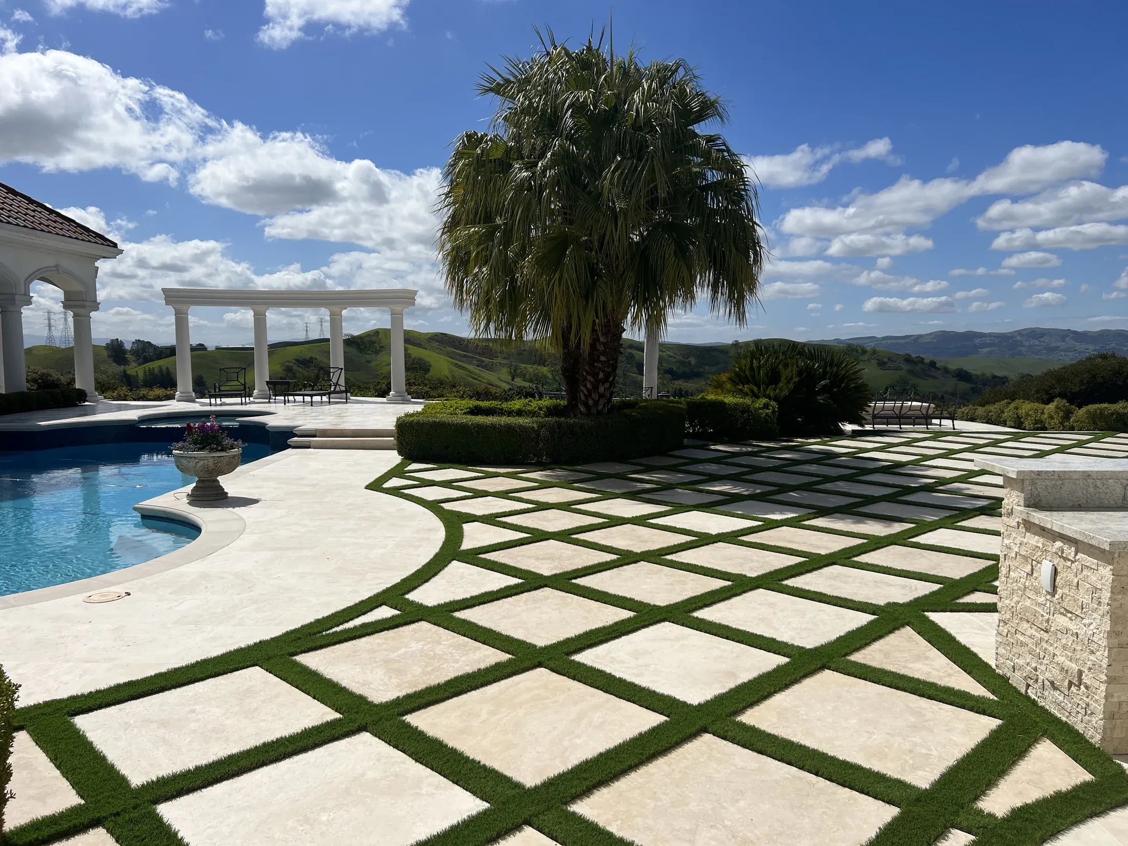 Poolside estate with formal paving and cast stone details