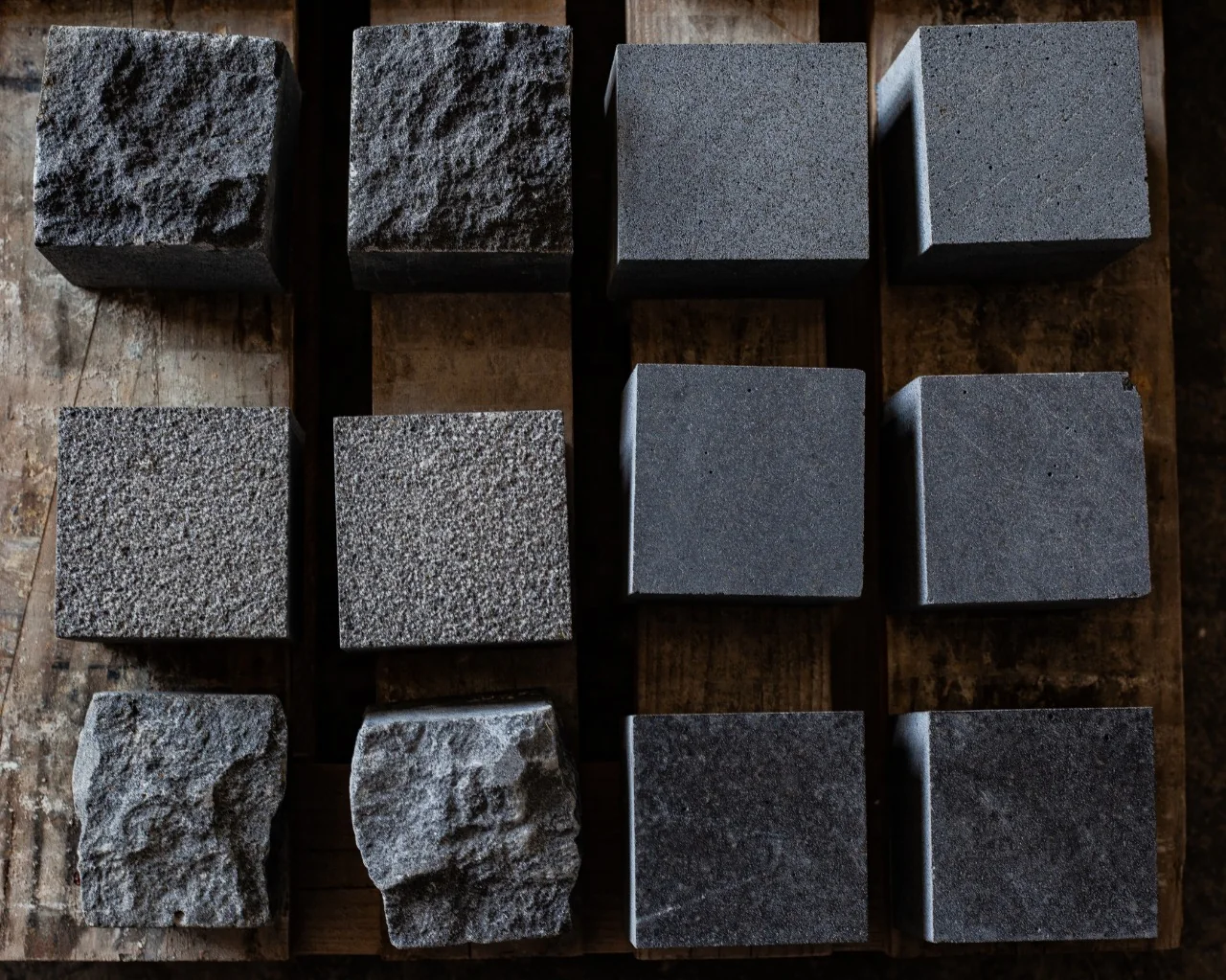 Dark paving blocks with contrasting smooth and rough surface finishes